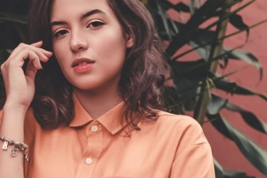 Model girl posing in an orange shirt